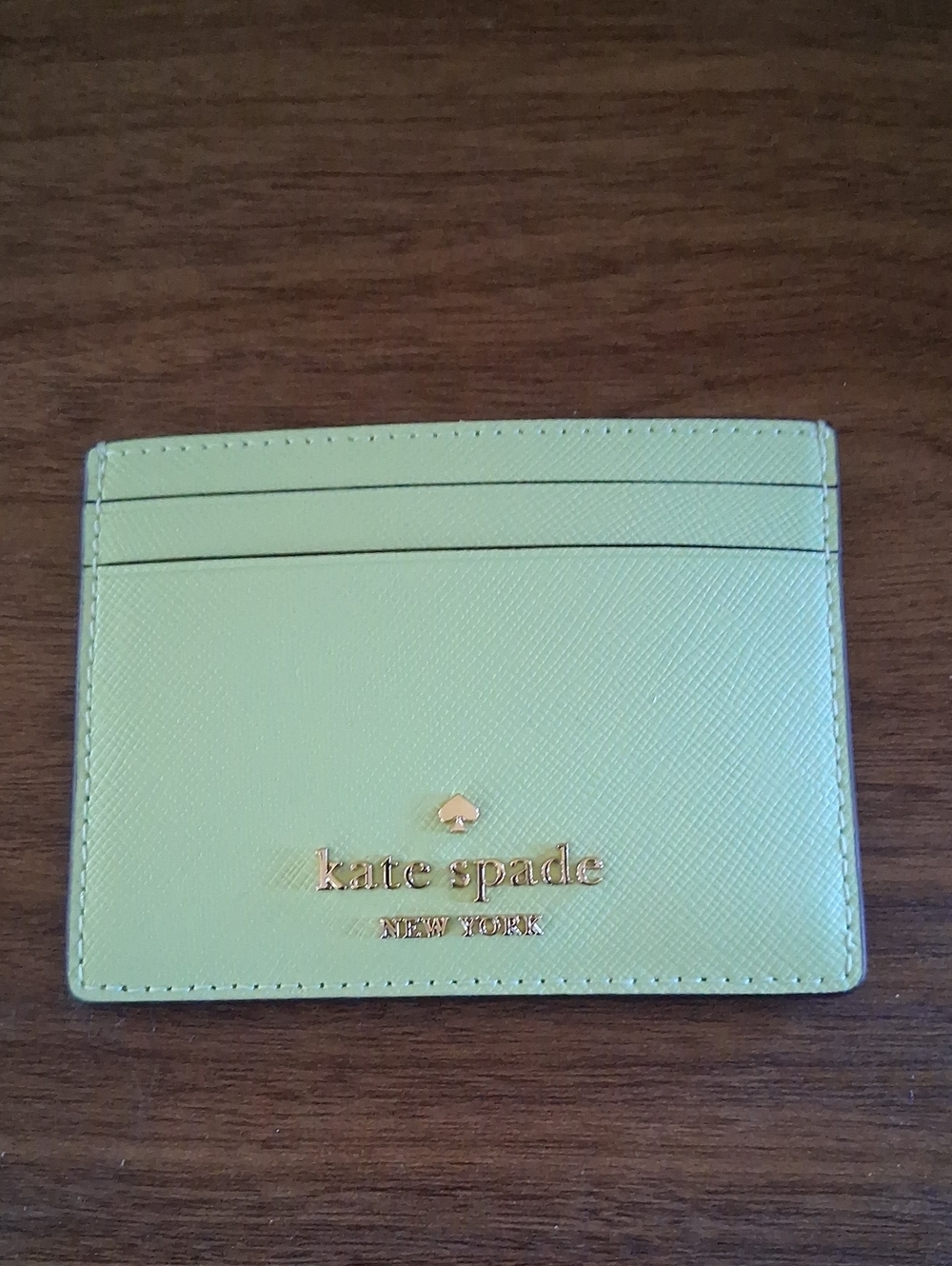 NWT Kate Spade mint green card case with gold logo